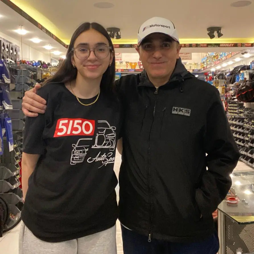 Girl wearing a black BMW t-shirt, featuring E30 M3 and G80 M3 profiles.