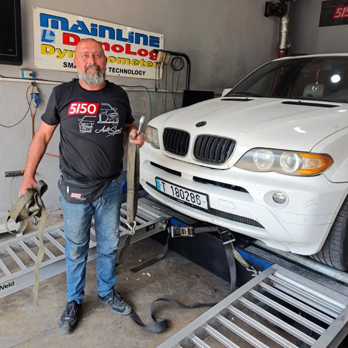 Man wearing black 5150 AutoSport BMW themed t-shirt