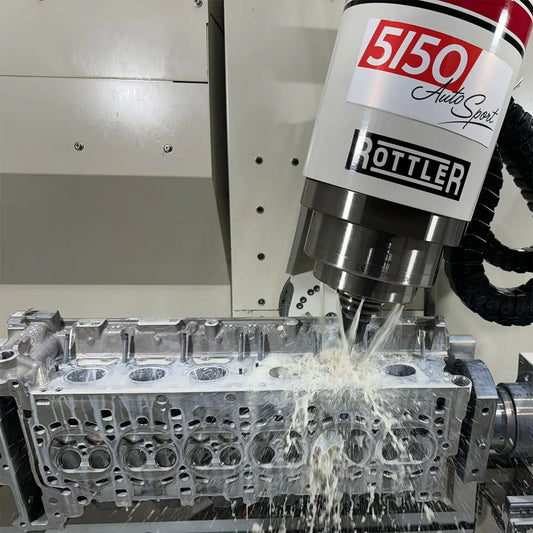 Rottler CNC machine porting a BMW S58 cylinder head for racing applications.