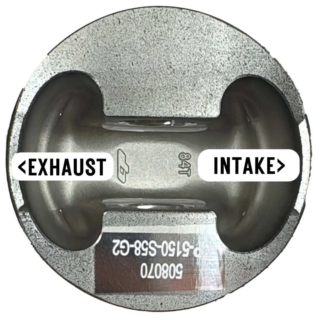 Photo of a piston indicating the intake and exhaust sides